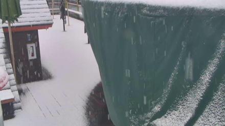 Rooftop deck view over Kings Beach, showing street, Lake Tahoe shoreline and surrounding mountain scenery.