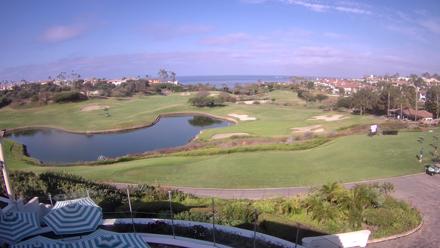 Golf fairway and ocean beyond at Monarch Beach Golf Links with coastal greens and blue sky