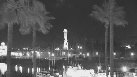 Lighthouse and harbor docks at Long Beach with palm trees and calm waters in view