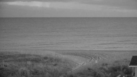 Wide ocean view from Holden Beach looking toward shoreline and horizon under a soft sky
