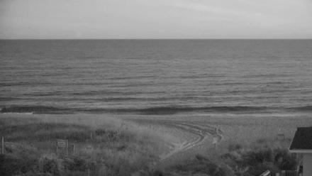 Wide ocean view from Holden Beach looking toward shoreline and horizon under a soft sky