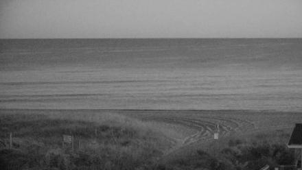 Wide ocean view from Holden Beach looking toward shoreline and horizon under a soft sky