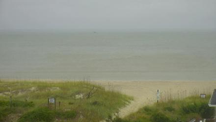 Wide ocean view from Holden Beach looking toward shoreline and horizon under a soft sky