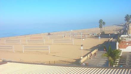 Pier stretching into the Pacific at Hermosa Beach North, with waves and coastal sky in view