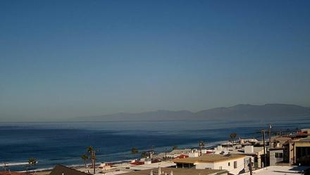 Fixed Santa Monica Bay live webcam view from Manhattan Beach CA looking toward Malibu mountains and open Pacific water.
