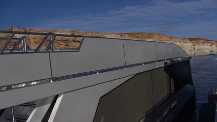 Boats moored at Antelope Point Marina on Lake Powell with sandstone cliffs and serene water reflections