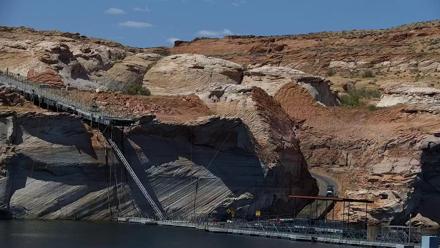 Boats moored at Antelope Point Marina on Lake Powell with sandstone cliffs and serene water reflections