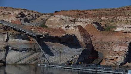 Boats moored at Antelope Point Marina on Lake Powell with sandstone cliffs and serene water reflections