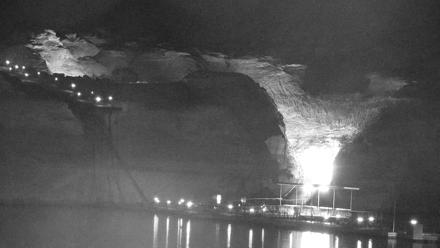 Boats moored at Antelope Point Marina on Lake Powell with sandstone cliffs and serene water reflections